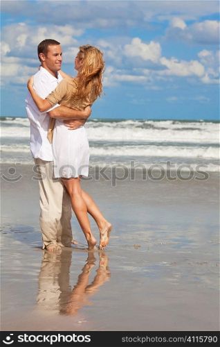 A young man and woman having fun as a romantic couple on a beach