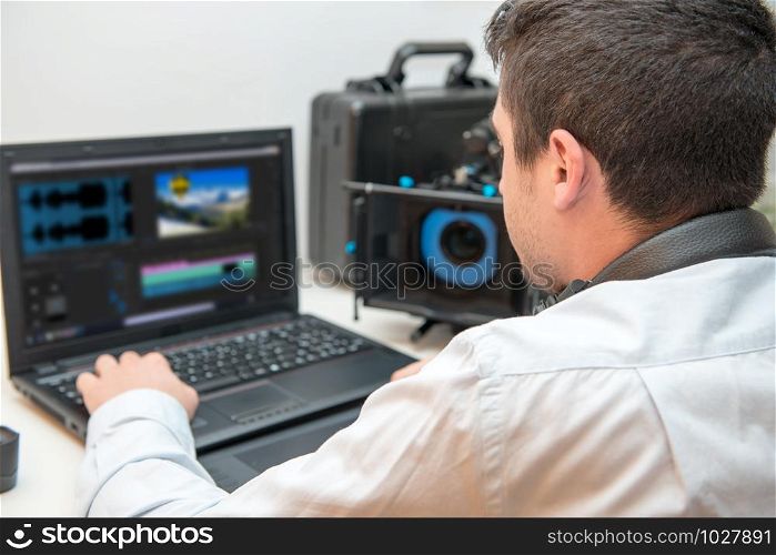 a young man designer using graphics tablet for video editing