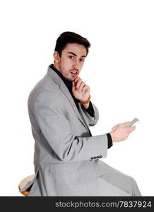 A young man holding on a cell phone in a black shirt with a beard, lookingvery scared, isolated for white background.