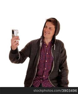A young man in a gray hoody and checkered shirt taking a picture ofhimself, isolated for white background.