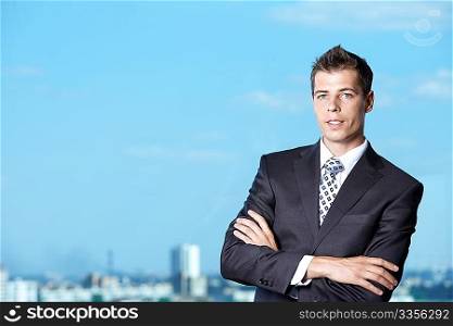 A young man in a suit against the sky