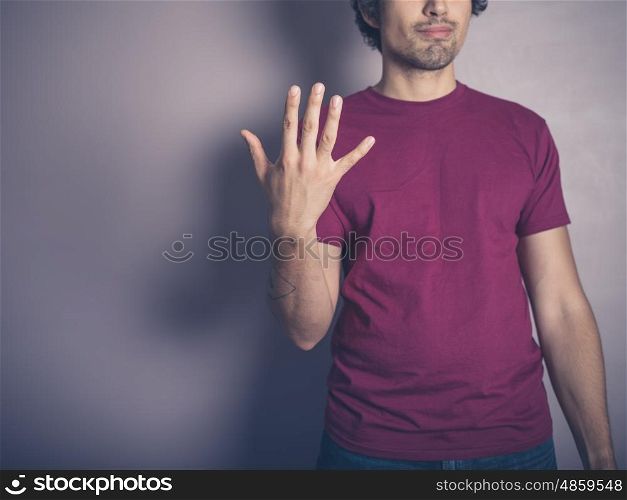 A young man in purple is waving