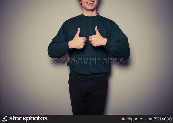 A young man is giving thumbs up in approval
