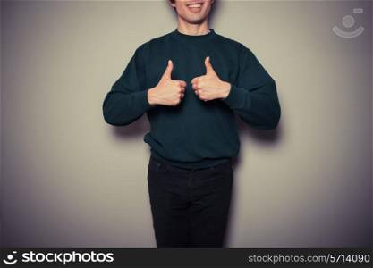 A young man is giving thumbs up in approval