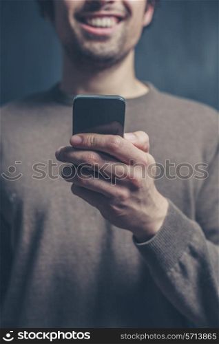 A young man is using a smart phone