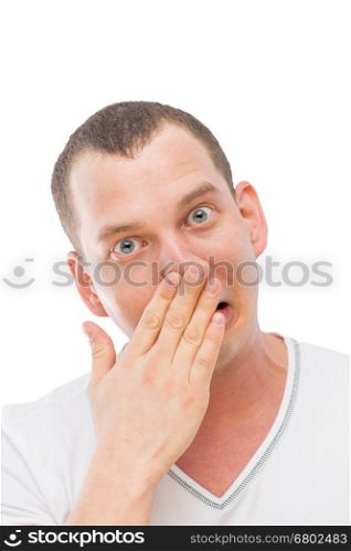 a young man makes a face, rubbing his nose with his hand isolated