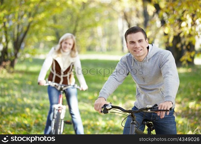 A young man on a bicycle in the foreground