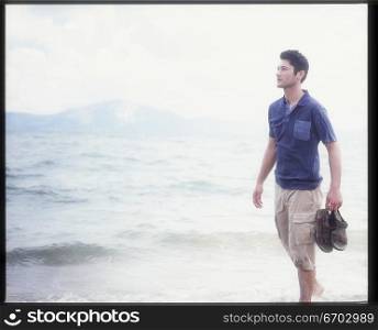A young man relaxes by the sea.