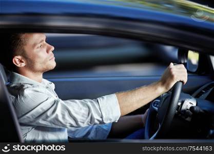 A young man rides in a car at high speed