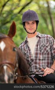 a young man riding a horse