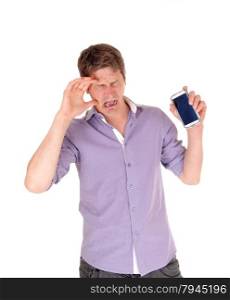 A young man standing crying isolated for white background holding his brokencell phone.