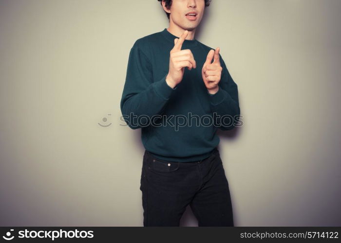 A Young man thinks he is cool and is making urban gestures with his hands