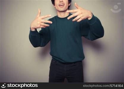 A Young man thinks he is cool and is making urban gestures with his hands