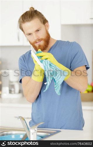 a young man washing dishes