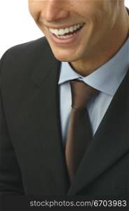 A young man wearing a suit smiling with perfectly white teeth.
