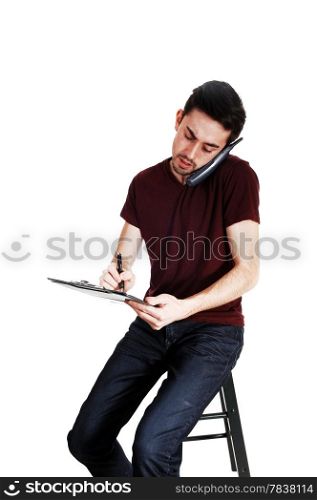 A young man with a phone on his ear and writing on his clipboard,isolated for white background.