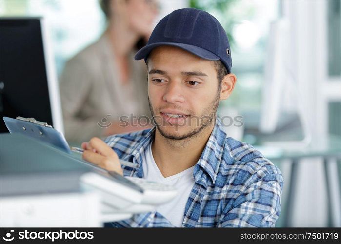 a young man with clipboard
