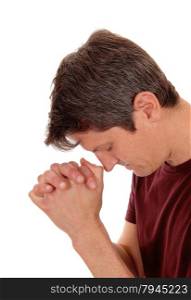 A young man with folded hands praying in closeup, isolated forwhite background.