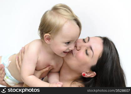 a young mother kissing her little baby