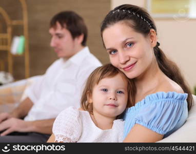 a young mother playing with her little baby at home