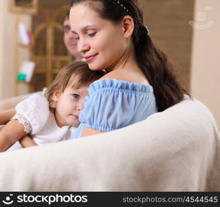 a young mother playing with her little baby at home