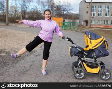 a young mother with a toddler combines walk in a stroller fitness