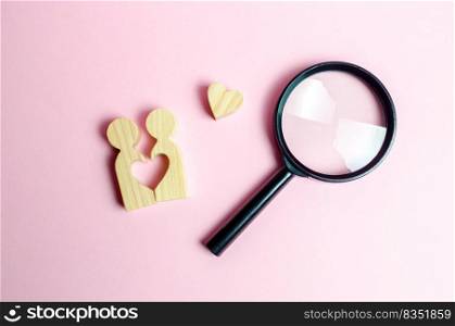 A young pair of lovers and a magnifying glass. Search for love and creation of strong love relationships. Dating and flirt, search for a love partner. concept of finding a couple on Valentine&rsquo;s Day.