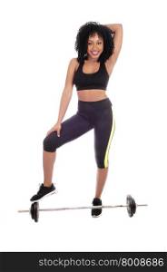 A young pretty African American woman in exercising outfit standing on weight&rsquo;s, with black curly hair, isolated for white background.