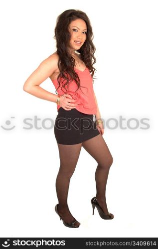 A young pretty Asian woman standing in the studio with her long brunettehair and a short skirt and heels, for white background.