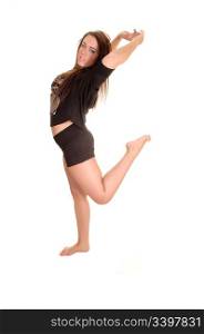 A young pretty girl doing gymnastic in the studio, in shorts and barefeet, for white background.