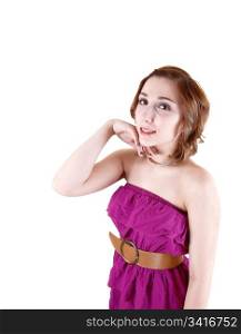A young pretty girl in a pink strapless dress dress standing in the studioin a portrait shot for white background.
