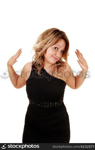 A young pretty woman in a black dress for white background gesturedwith her hands, I dona??t know anything, and smiling into the camera.