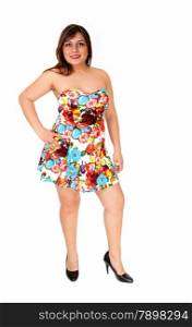 A young pretty woman in a colorful summer dress standing from the front,isolated for white background.