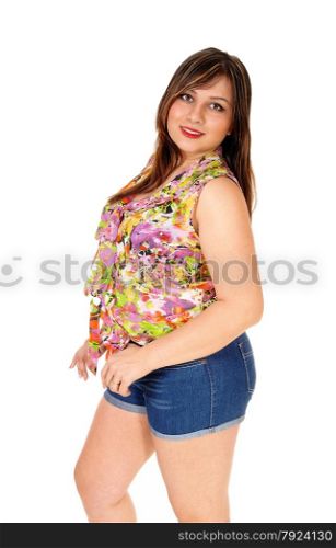 A young pretty woman in jeans shorts standing in profileand looking over her shoulder, isolated for white background.