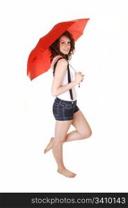 A young pretty woman in jeans shorts with suspender and a white t-shirtstanding bare feet and holding an umbrella over her shoulder, over white.