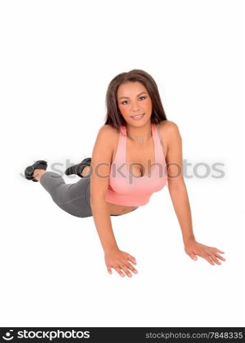 A young pretty woman lying on the floor and doing push up&rsquo;sisolated on white background.