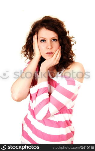 A young pretty woman standing and holding her head, in an pink whitesweater for white background.