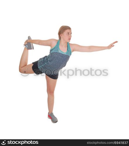 A young pretty woman standing isolated for white background stretching her body with one leg up and outstretched arm