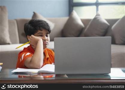 A YOUNG SCHOOL KID FEELING SLEEPY DURING ONLINE CLASS