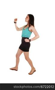 A young slim woman in a black skirt and green t-shirt running in the studiofor exercise, for white background.
