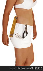 A young slim woman in white shorts and a white bra with some tools inher shorts, planning to do some repair in her home, for white background.