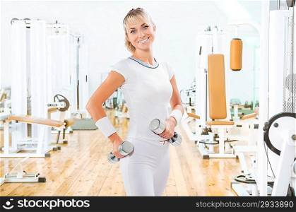 a young sports girl holding weights