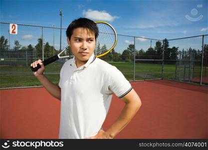 A young sporty asian man playing tennis