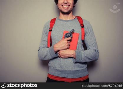 A Young student is holding a red book and a revolver