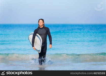 A young surfer with his board on the beach. Ocean is my life