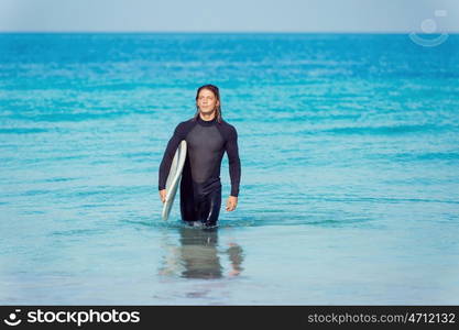 A young surfer with his board on the beach. Ocean is my life