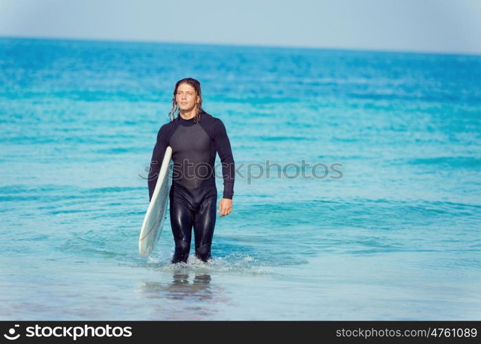 A young surfer with his board on the beach. Ocean is my life