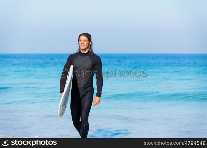 A young surfer with his board on the beach. Ocean is my life