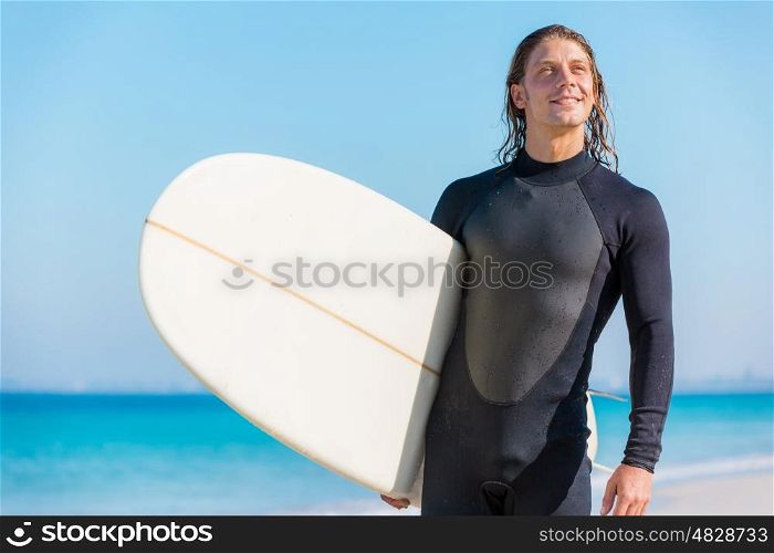 A young surfer with his board on the beach. Ocean is my life