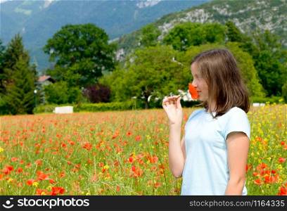 a young teenage girl in poppy field